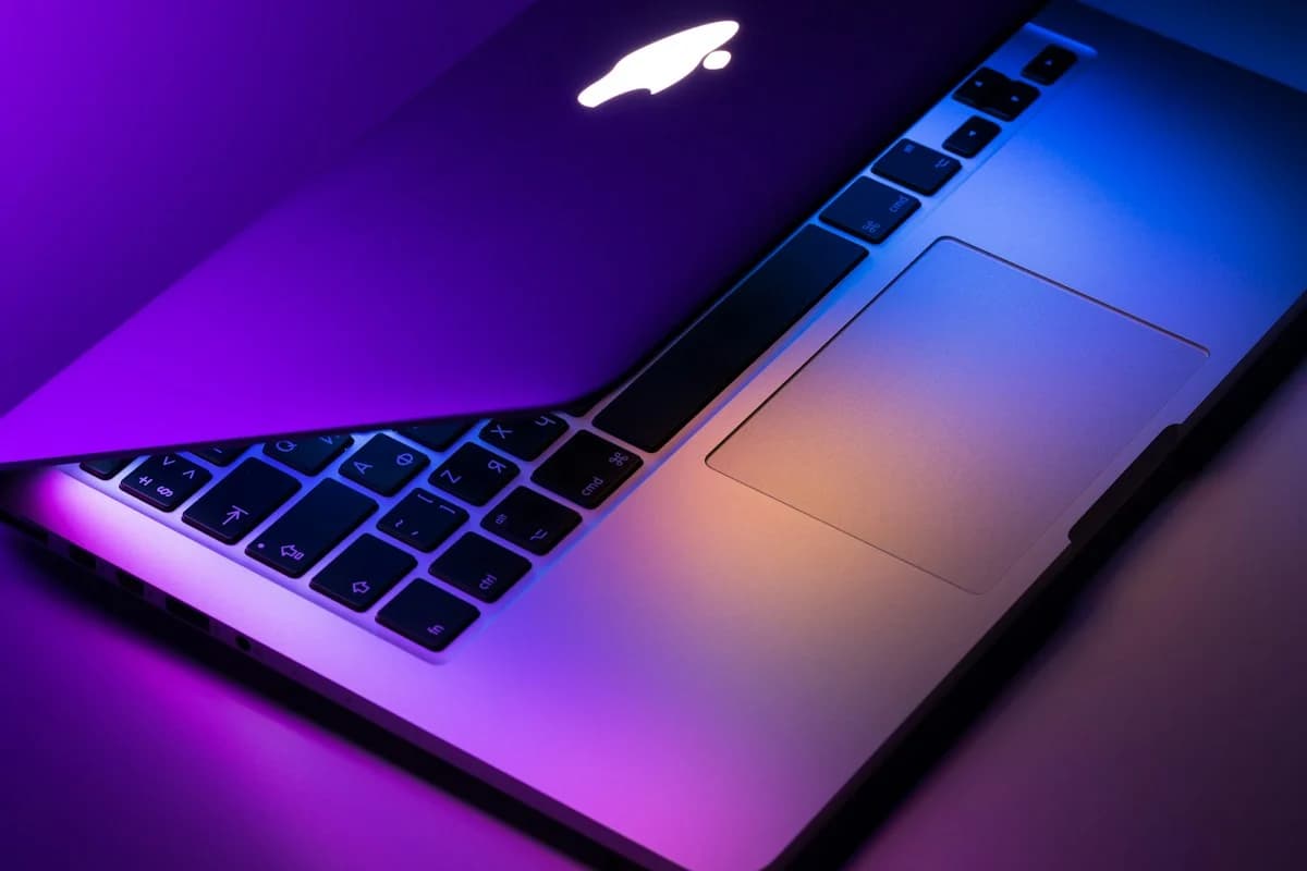 Space gray laptop open on a dark table surface