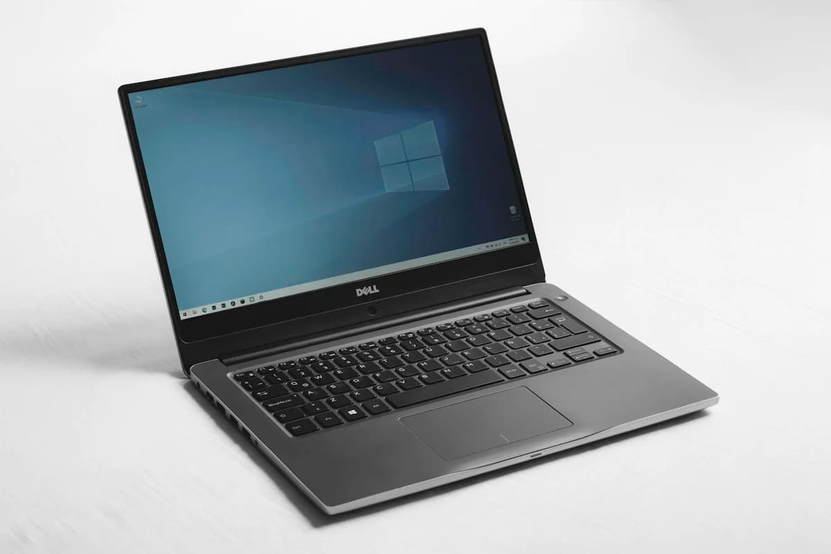 Laptop, tablet and office peripherals arranged on a bright desk